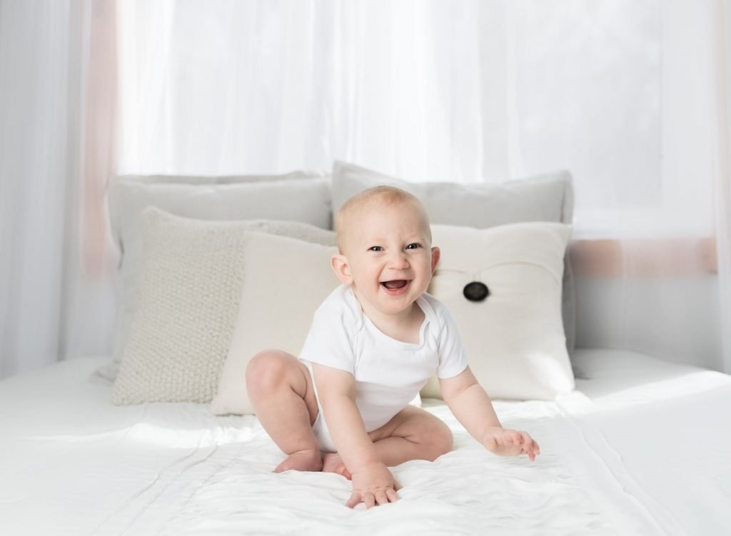 Image of Laughing Baby Wearing White Shirt