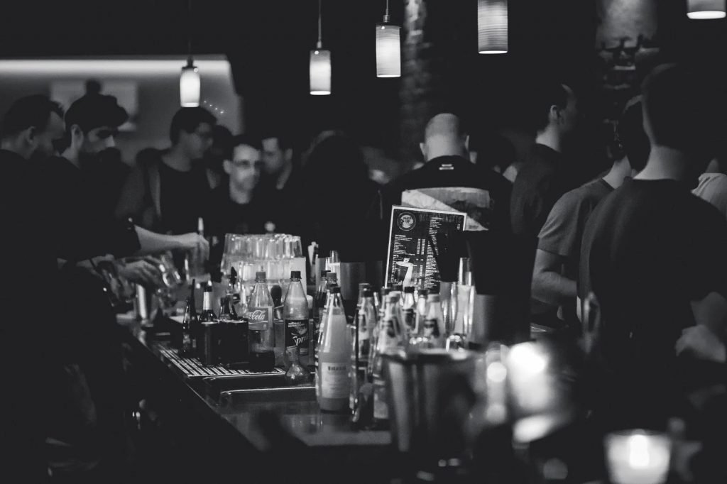 Image of Grayscale Photography of Bottles on Top of Table