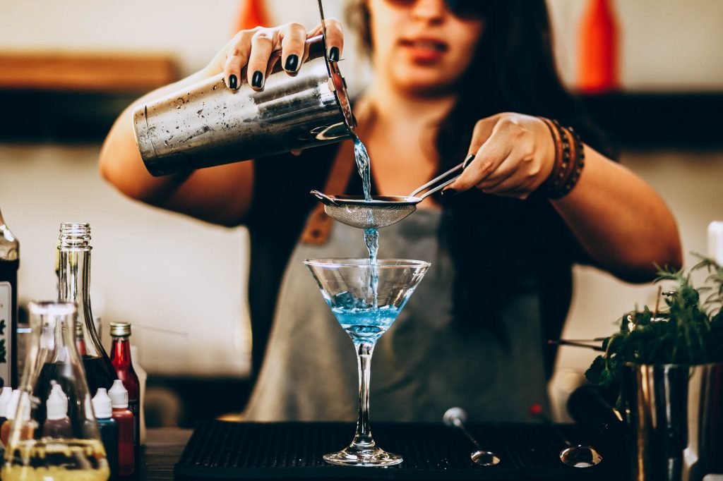 Image of Photo of Woman Pouring Liquid From Drink Mixer