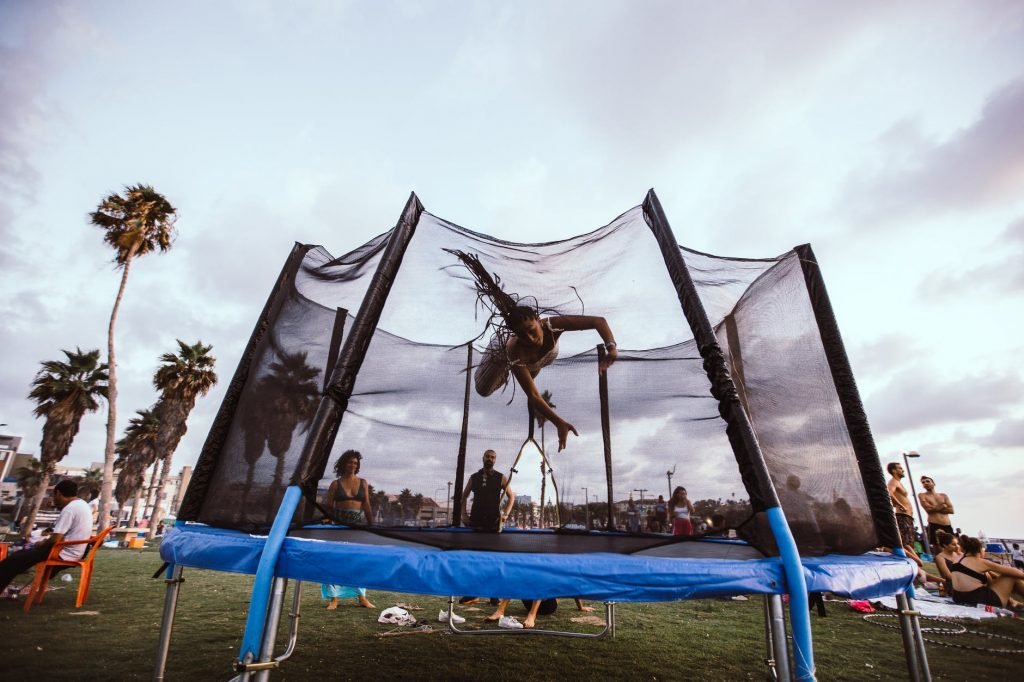 Image of Anonymous athlete jumper bouncing on trampoline