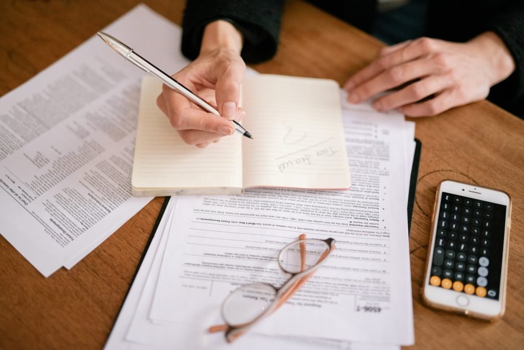 Image of Person Writing on White Paper