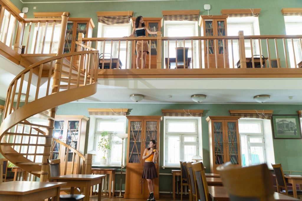 Image of Women Posing while in a Library