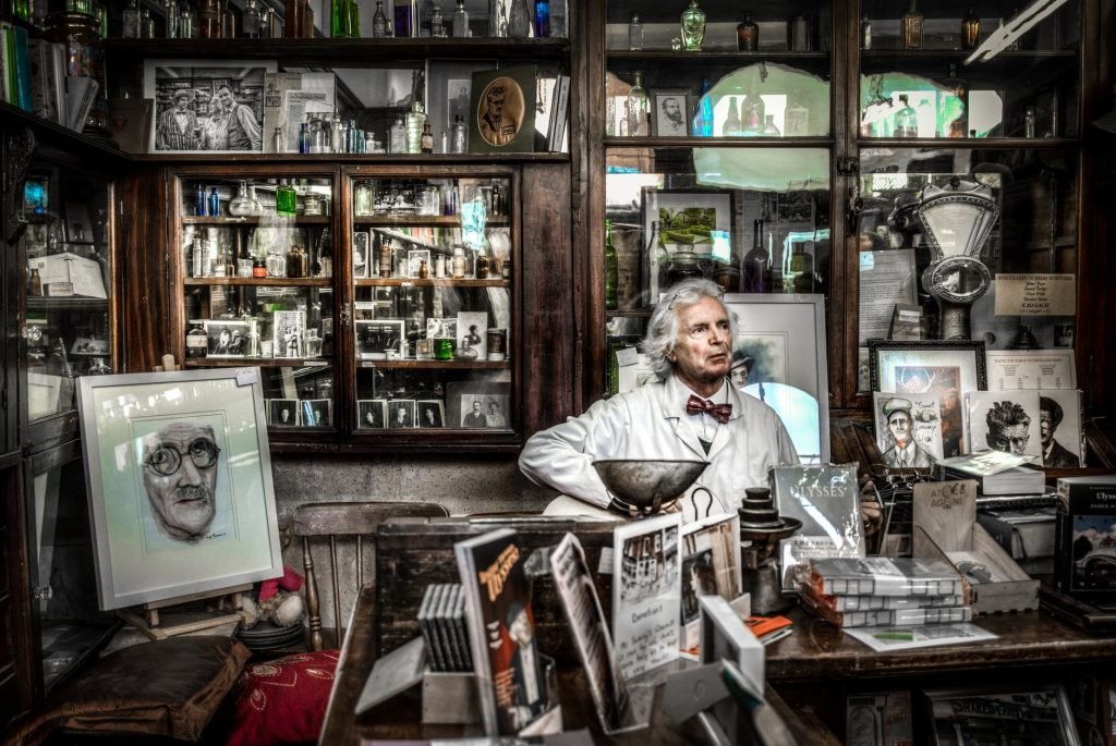 Image of Man Sitting Behind Book Collection