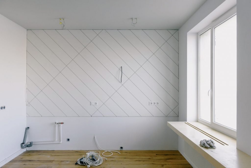 Image of Renovation in light room with wooden laminate