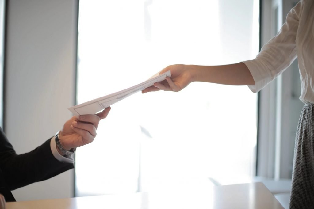 Image of Job Applicant Passing Her Documents