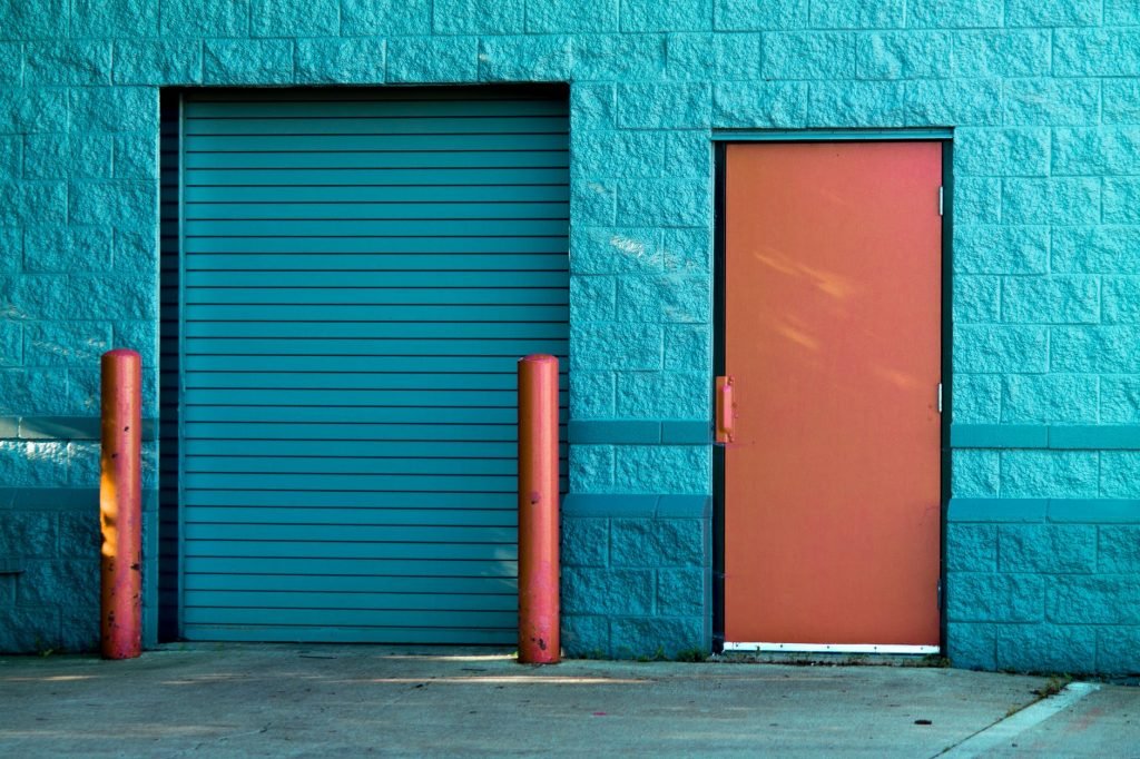 Image of Brown Panel Door Near Roll-up Gate