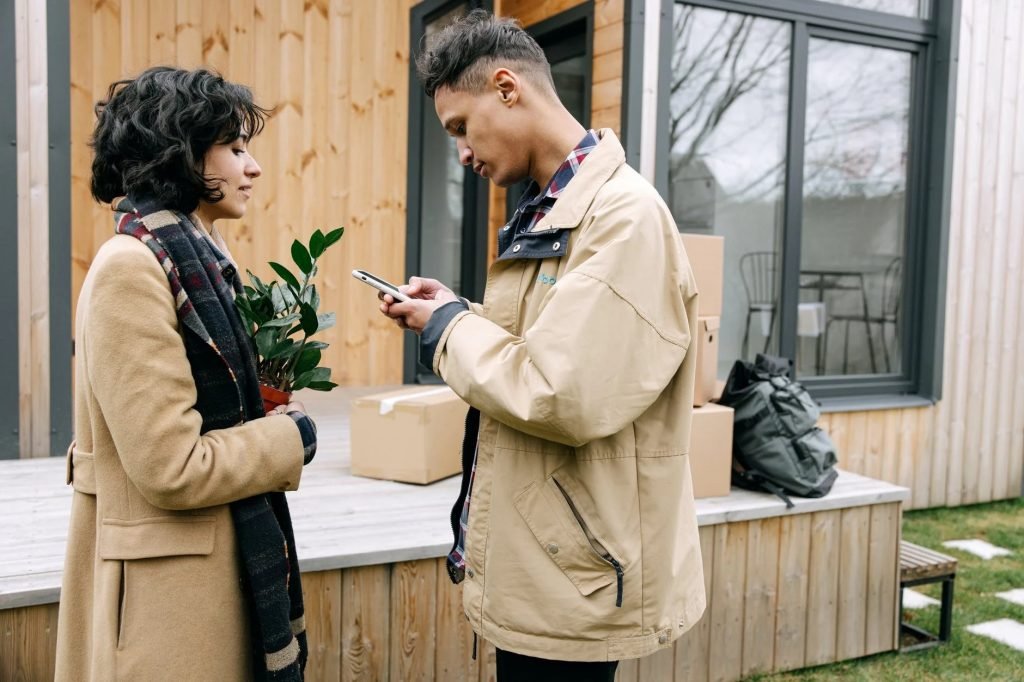 Image of A Woman Looking at the Man Using Mobile Phone