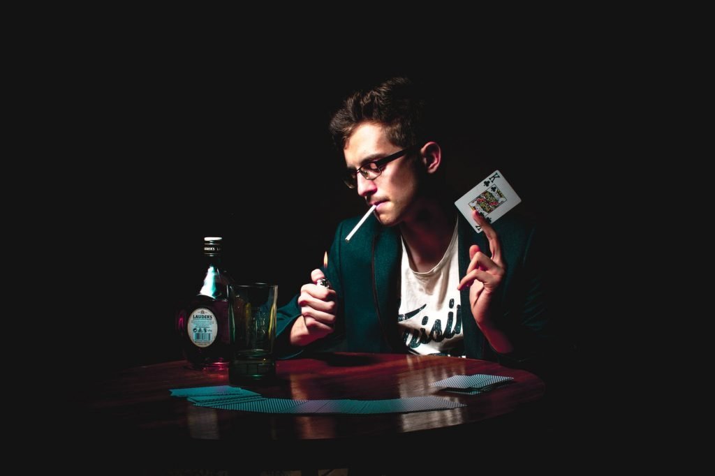 Image of Photo of Man Holding Playing Card