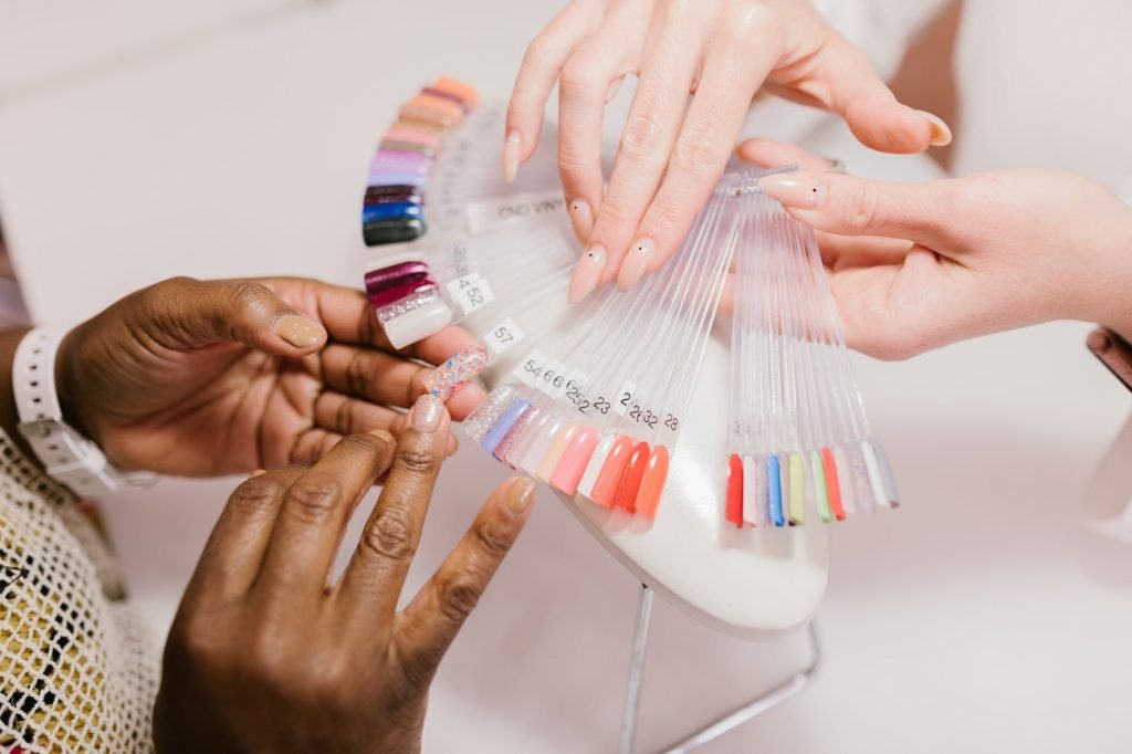Image of A Client Choosing on a Nail Color Palette