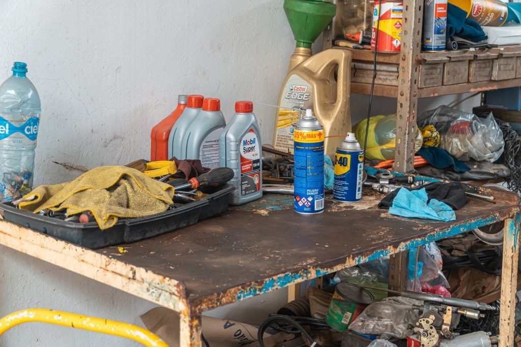 Image of Automotive Oil Containers On A Rusty Table
