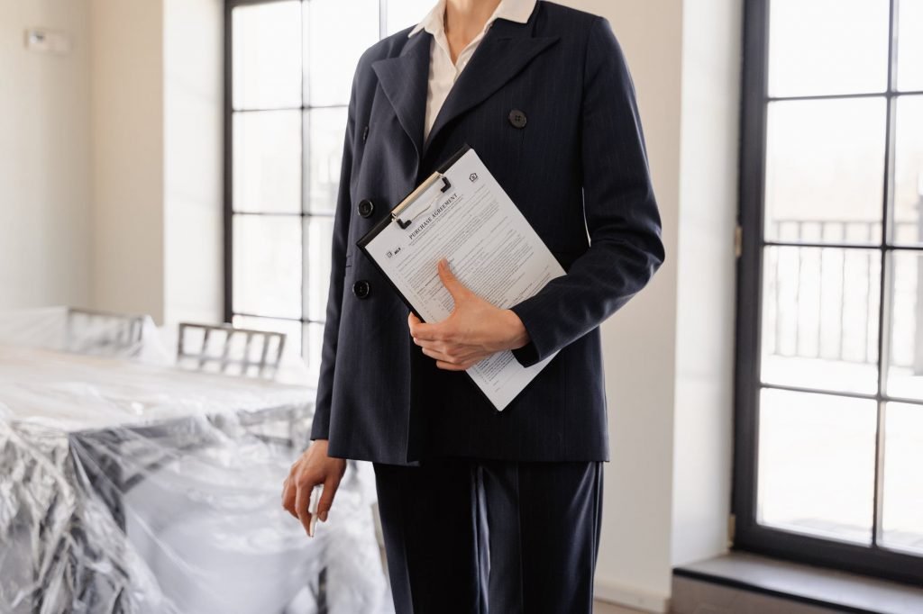Image of Person in Black Blazer Holding a Documents