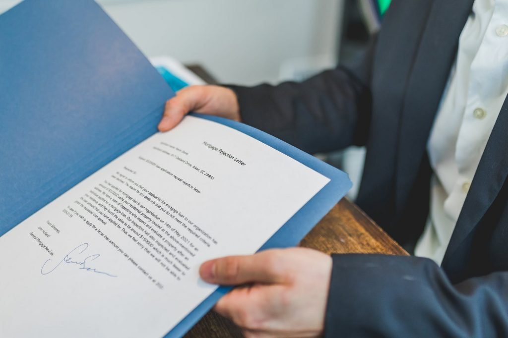 Image of Person Holding White Printer Paper