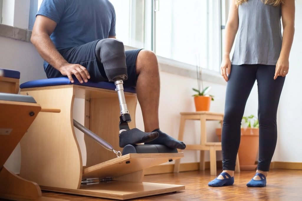 Image of A Sitting Man Rehabilitating with a Prosthetic Leg