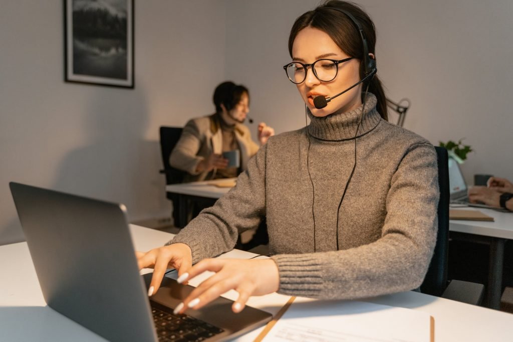 Image of Woman in Gray Sweater Working as a Call Center Agent