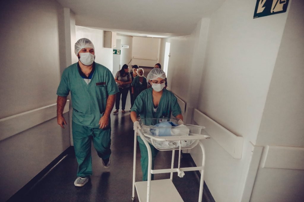 Image of nurse carrying newborn baby