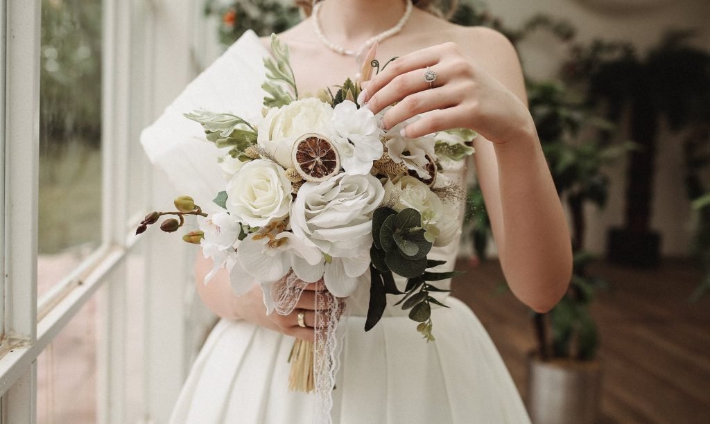 Image of Woman in White Wedding Dress Holding Bridal Bouquet