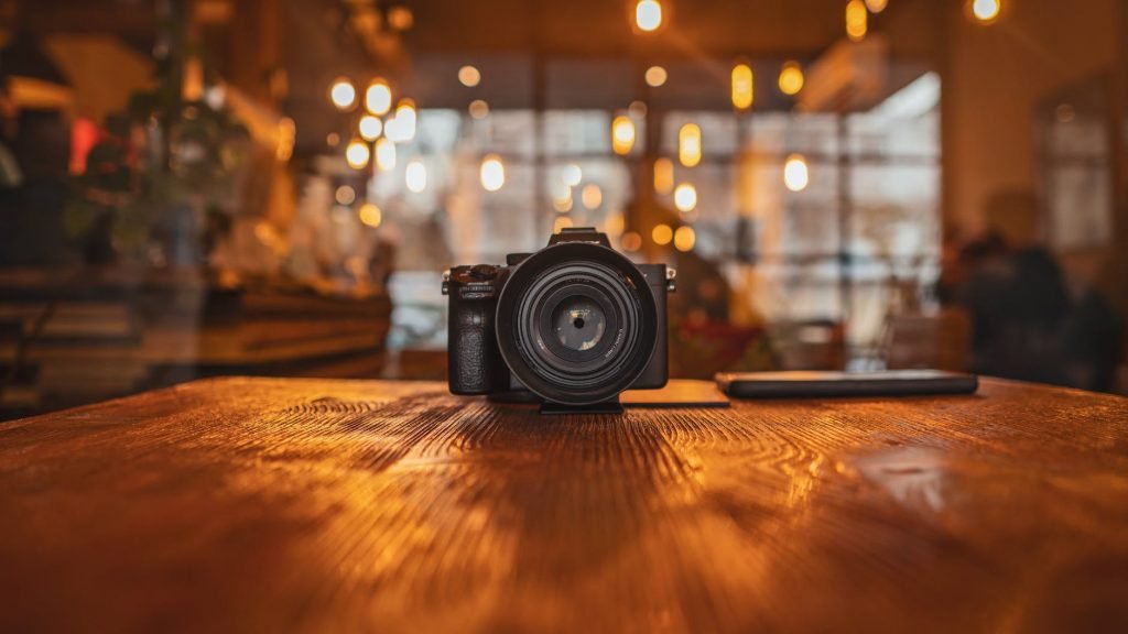 Image of Black Dslr Camera on Brown Wooden Table