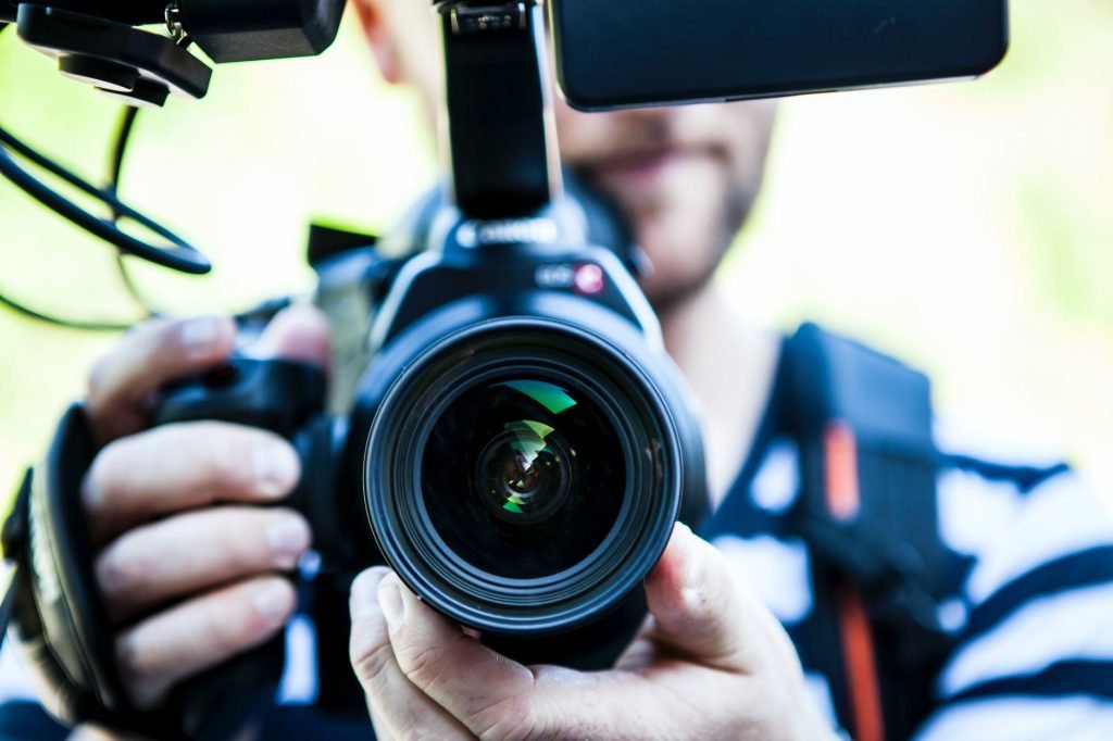 Image of Person Holding Canon Dslr Camera Close-up Photo