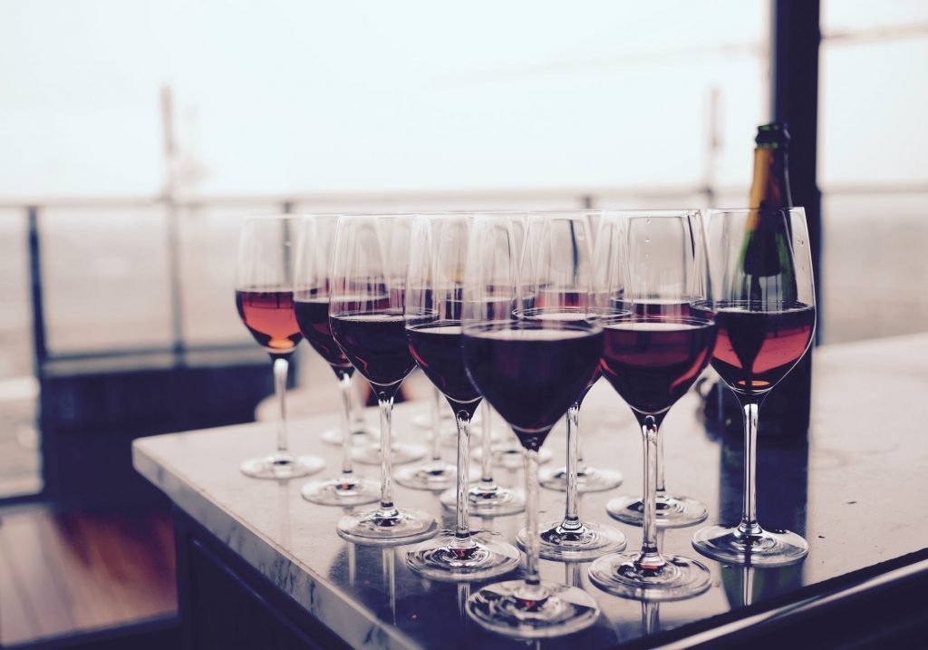 Image of Wine Glass With Red Liquid on Black Table