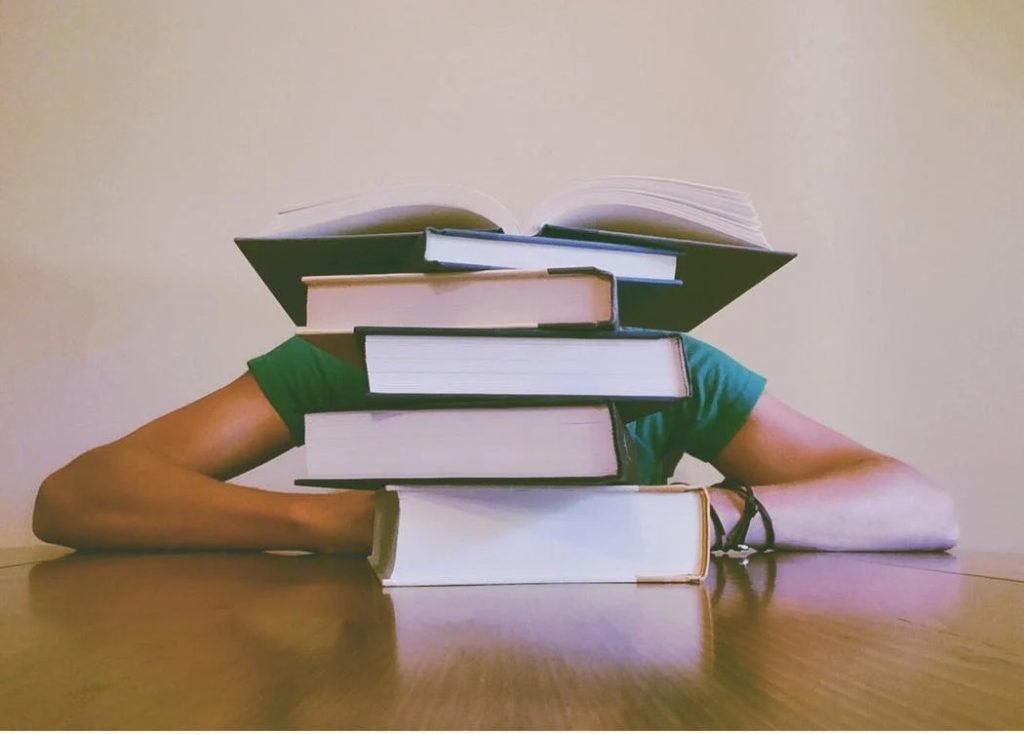 Image of Person Behind Books
