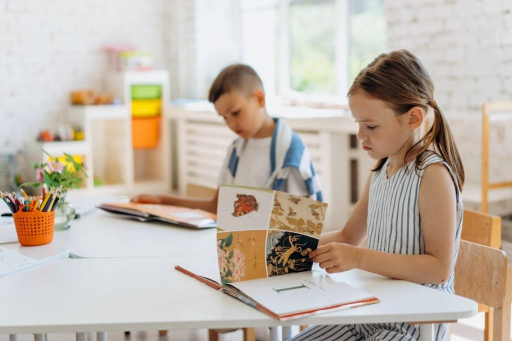 Image of Kids Sitting Looking at the Books